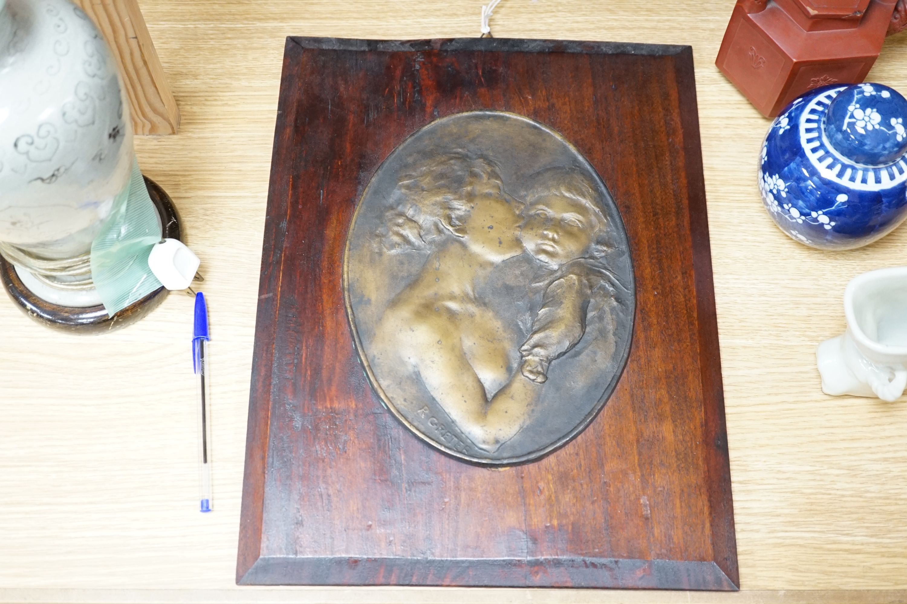 Robert Greter - oval relief plaque of a mother and child, mounted on board, plaque 26x19cm